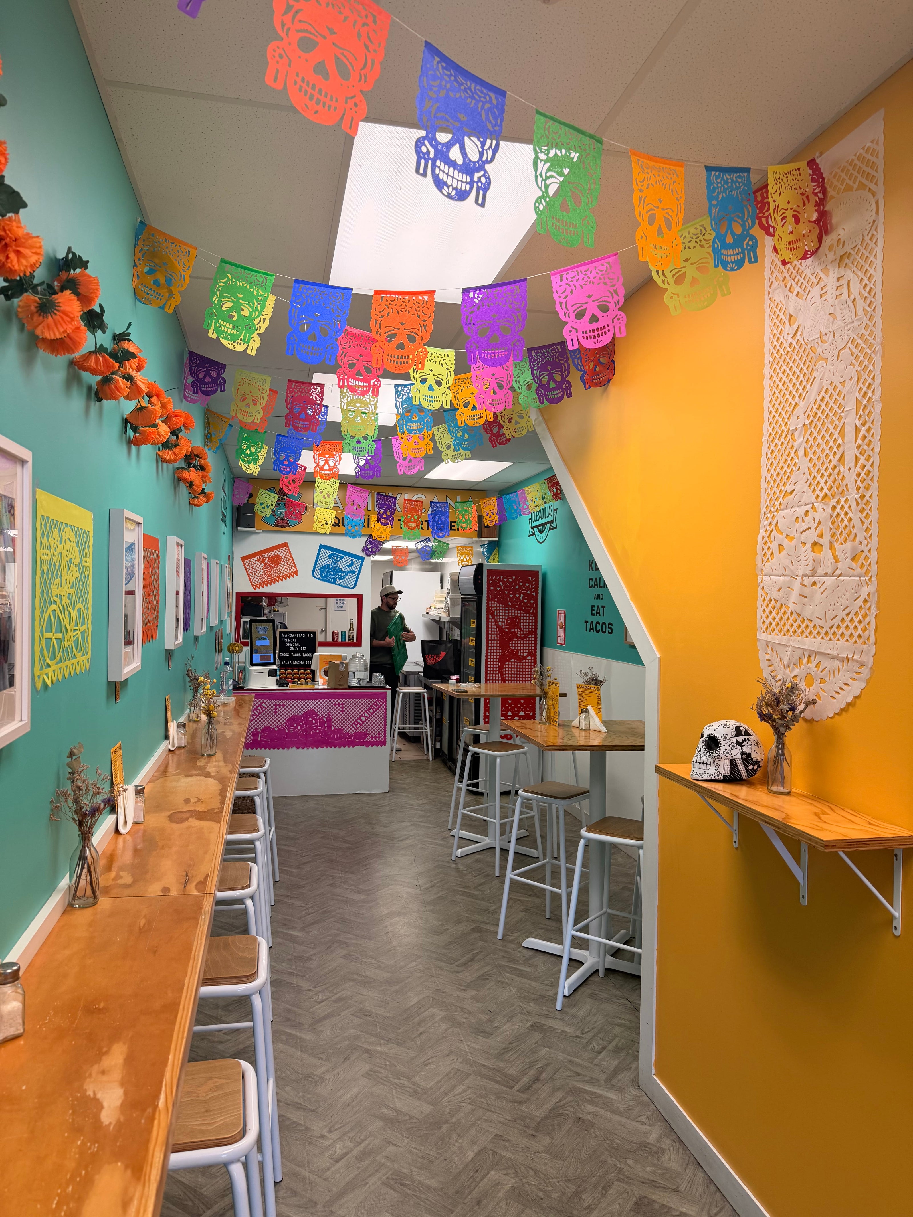 Colorful paper cutouts on a wall and ceiling of the restaurant