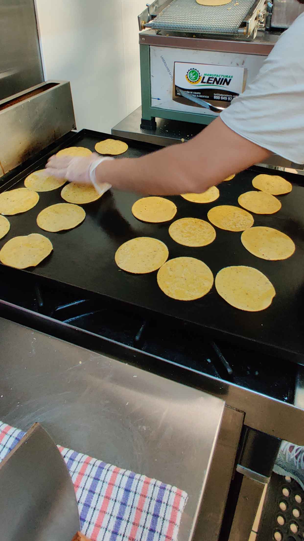 Corn tortillas are being baked on the spot